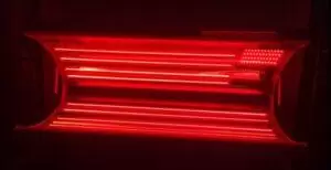 Red Light Therapy Bed in a dark room